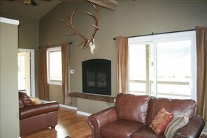 The living room has large picture windows and patio door leading to the porch.