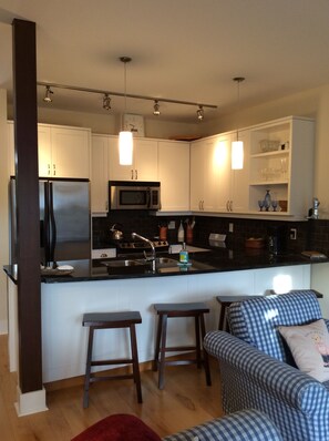 Bright kitchen with granite and eating bar