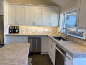 Slab Quarzite counters, marble backsplash. All new appliances