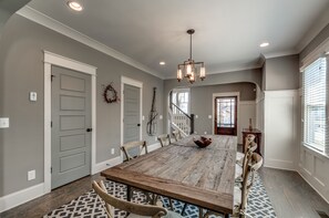 Dining table of steel & reclaimed wood seats 10; handy ½ bath; cloak closet