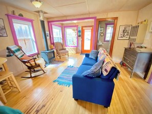 Spacious living room. Read by natural light next to a cozy fireplace.