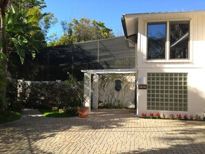 The front double door and glass block entrance with a wall fountain to greet you