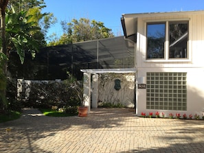 The front double door and glass block entrance with a wall fountain to greet you