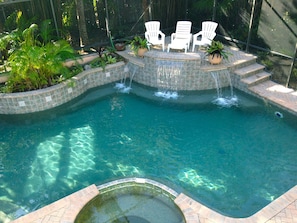 The in-ground spa and pool with a view of the sunbathing landing and waterfalls.