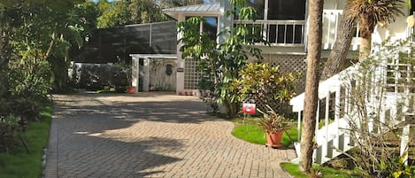 The Tree House front and paver driveway.  Front staircase landing and balcony.