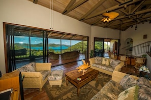 Sunken Spacious  Living Room with Wet Bar Opening To A Large Veranda  