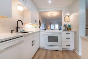 Range is open to the living area, the cook can converse while preparing meals