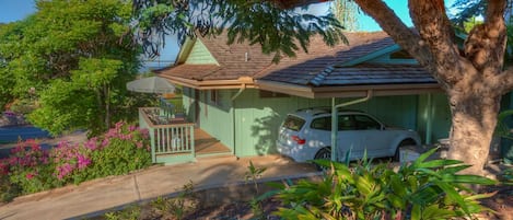 The cottage is surrounded by beautiful tropical flowers and trees