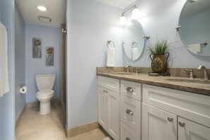 The master bath has double vanities and a walk-in tiled shower.