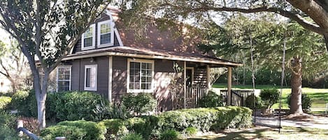 The 2-story cottage is nestled in your very own park-like setting