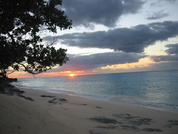 Beach at sunset in front of vacation beach house.