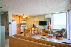 Kitchen with updated cabinets, dishwasher, granite countertops & a HD TV nearby