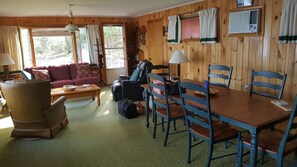 Large family room w/dining area. Couch opens into a queen bed. Door out to deck.