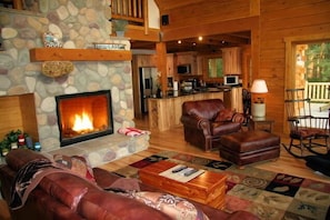 Great room with wood-burning fireplace,cathedral ceilings and fabulous lake view