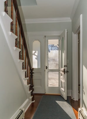 View from the living room to the front entry and stairs
