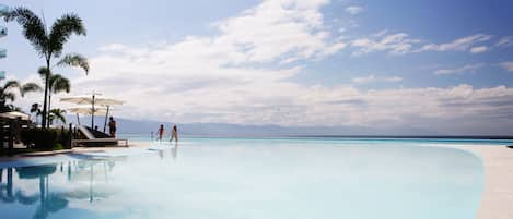 Day Beds & Lounge Chairs Line the Huge 120 Meter Swimming Pool. Western View