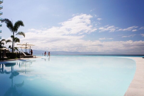 Day Beds & Lounge Chairs Line the Huge 120 Meter Swimming Pool. Western View