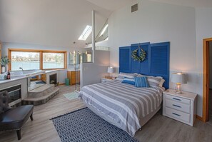 Master bedroom with Jacuzzi tub overlooking lake. 