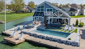 Private oasis with pool, covered outdoor kitchen, fireplace, firepit.