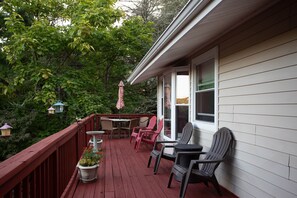 Patio chairs, table, umbrella on main deck