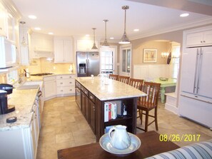 Kitchen with 2 full size refrigerators, 9' Island, Banquette