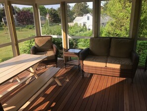 Screen enclosed porch with furniture
