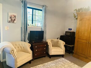 Sitting area with Roku TV, fridge and microwave 