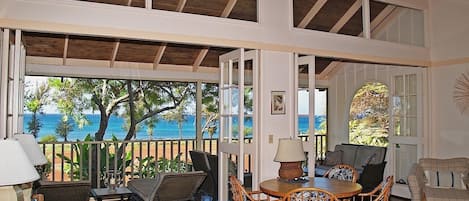 Living room with screened lanai with spectacular ocean and sunset views