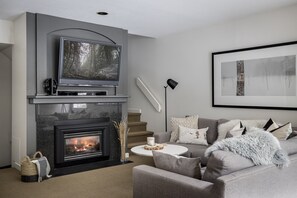Cozy up on the couch in front of the gas fireplace and watch TV