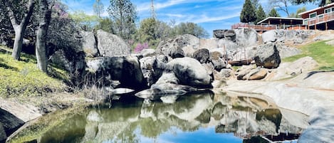 Majesticall pond surrounded by huge boulders.