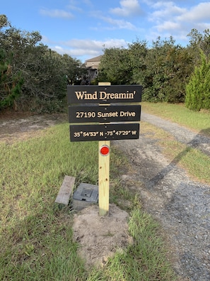 Sign at front of driveway.  Note the wooded drive into the property.