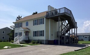 Front of house showing roof top deck with ocean views and parking for 6 cars