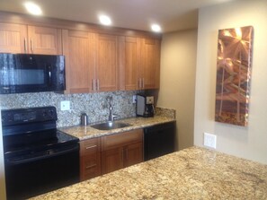 Bright beautiful kitchen with lots of counter space to make your island feasts!