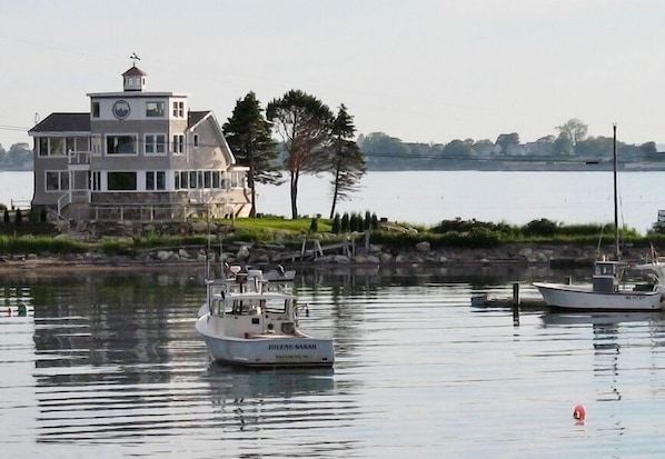 View of House from Cribstone Bridge;House is surrounded by water and boats