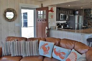 Couch facing east with views of beach, Garrison Cove, Cribstone Bridge & Orrs Is