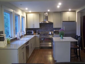 Fully equipped kitchen with all new appliances. It has cesarstone counter.