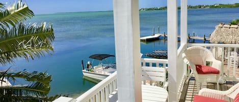 View of Atlantic Ocean, pool tiki hut, and docks from one of our porches.  