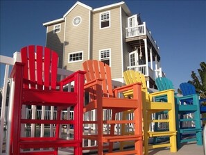 Island chairs overlook the ocean with the pool and our home in the background.