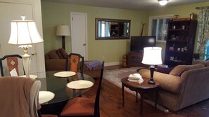 living area featuring rustic pine flooring. 70 channels of cable, and wifi