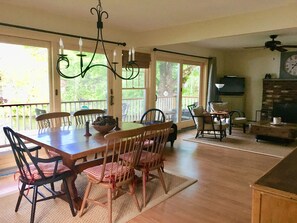 Dining room and and living room with sliders and large window 