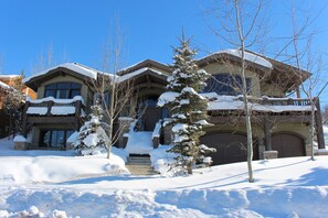 Front of house in winter, easy access due to heated driveway and heated garage