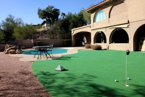 Backyard with putting green, pool, hot tub and more!