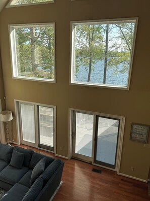 Multi story windows looking at lake from kitchen and family room main floor