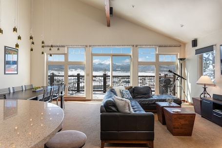 Main floor with large open plan living/dining and kitchen area and porch.