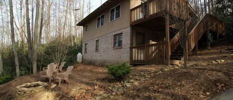 Cabin exterior and fire pit in winter, minus the snow