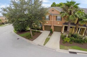 house on the corner with driveway and garage and automatic door