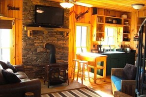 cozy cabin inside, with full kitchen and TV