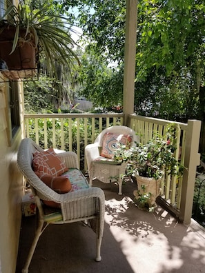 Back porch on lower level outside kitchen door overlooks private courtyard