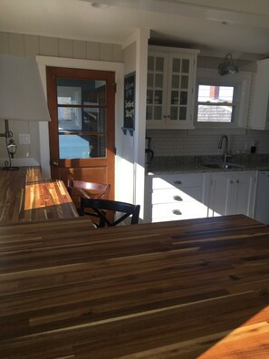 Open kitchen with two warm butcher block bars 