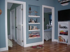 Bedroom entrances, built-in bookcase and flat panel TV